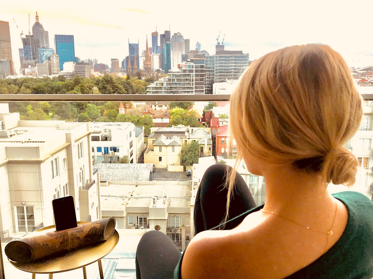 woman on balcony looks over city