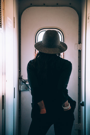 woman on train with hands in pockets