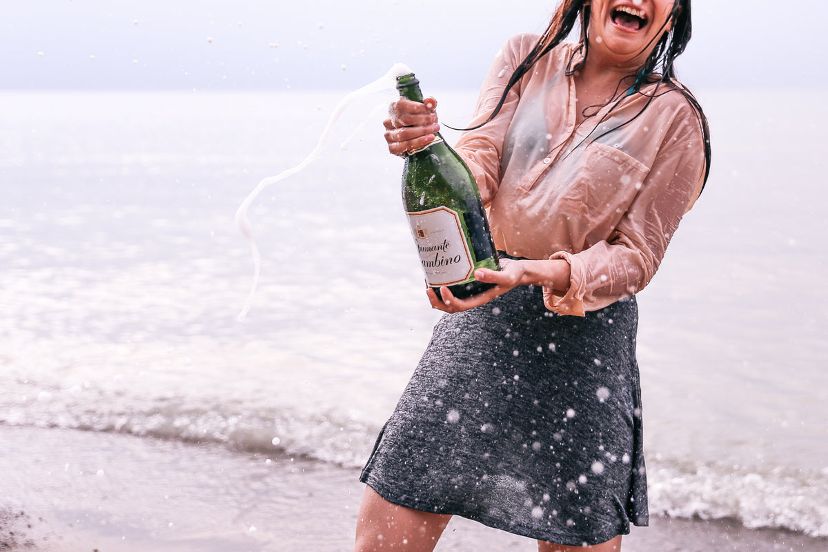 woman popping champagne