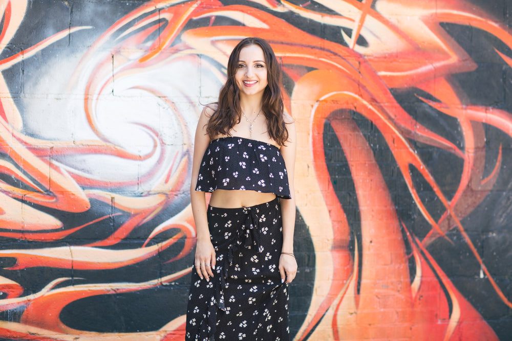 woman poses by alley wall