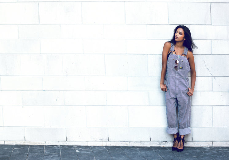 woman-poses-by-brick-wall-in-overalls.jpg?width=746&format=pjpg&exif=0&iptc=0