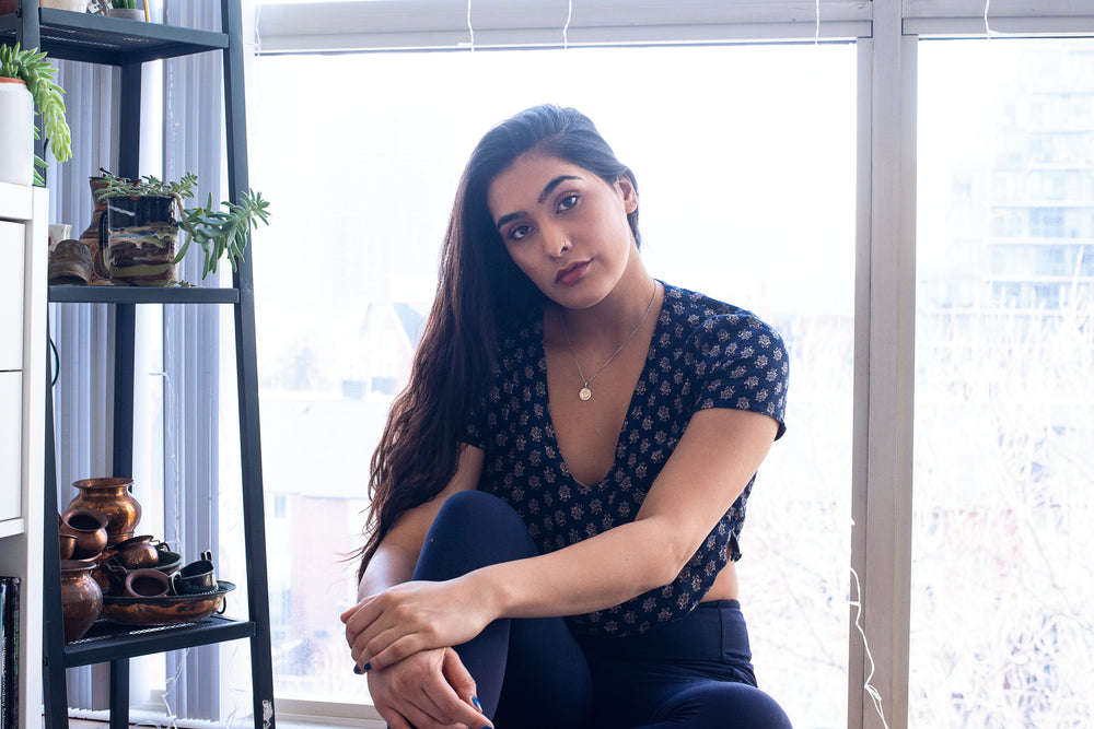 woman poses by large window