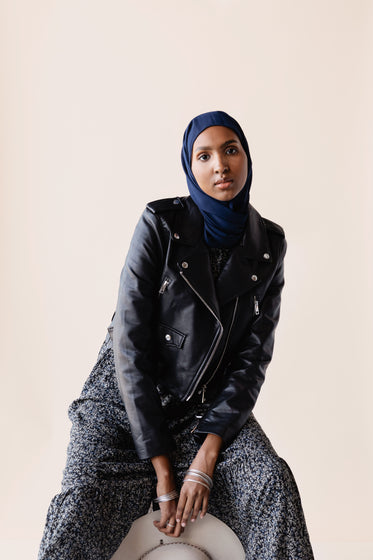 woman poses in a leather jacket