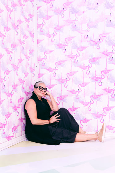 woman poses in pink room