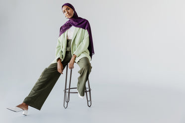 woman poses on a stool
