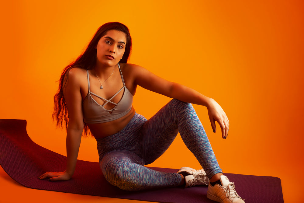 woman poses on yoga mat