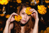 woman poses with orange blossoms