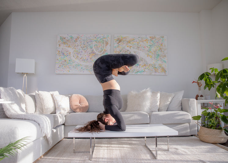 woman-practices-advanced-yoga-pose-on-co