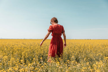 woman reaches for flowers