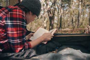 woman reading in tent