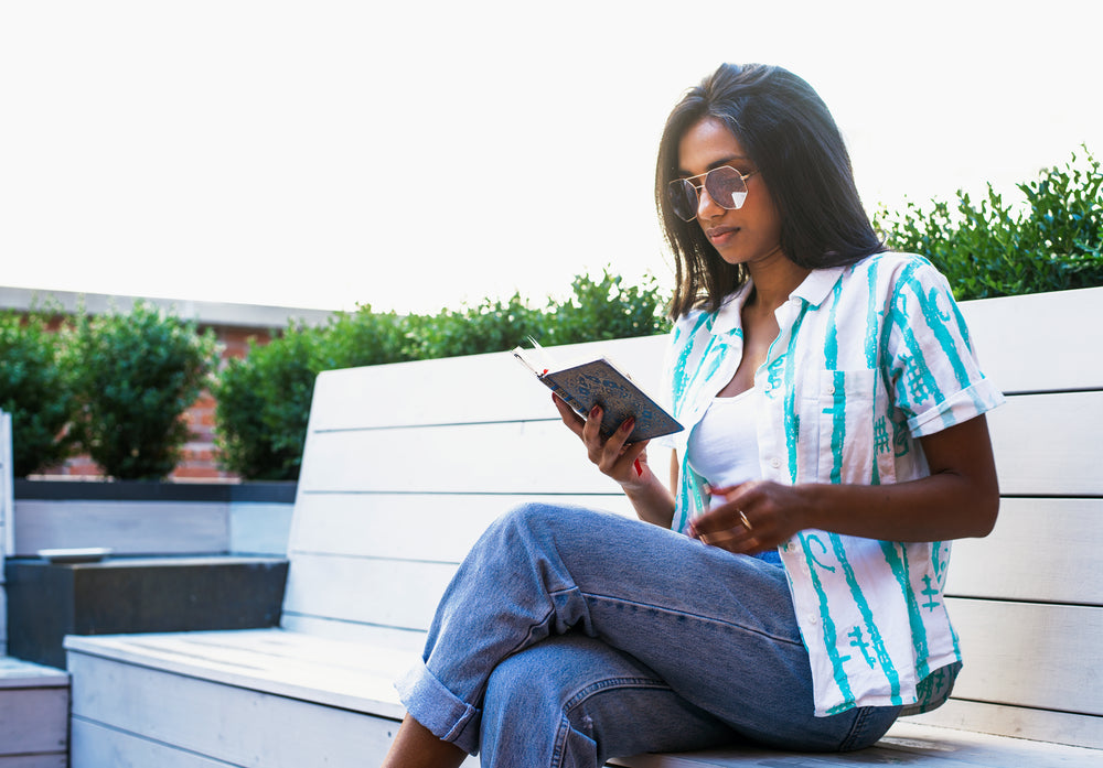 woman reading on park bench