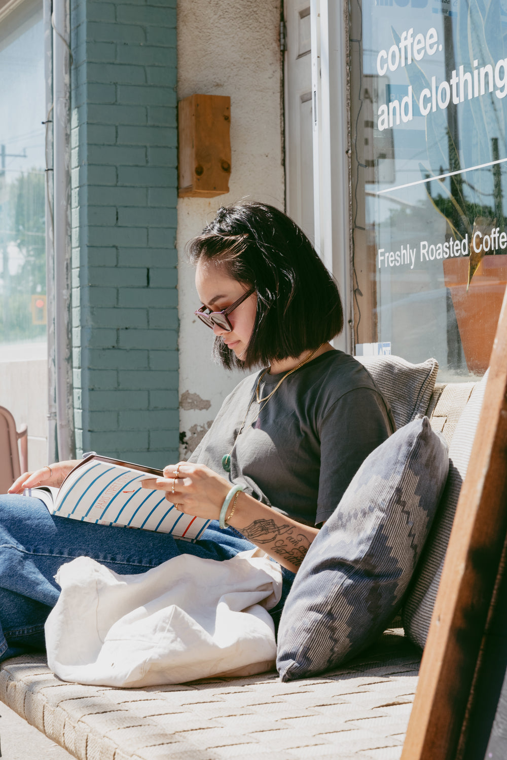 woman reads while seated in the sun