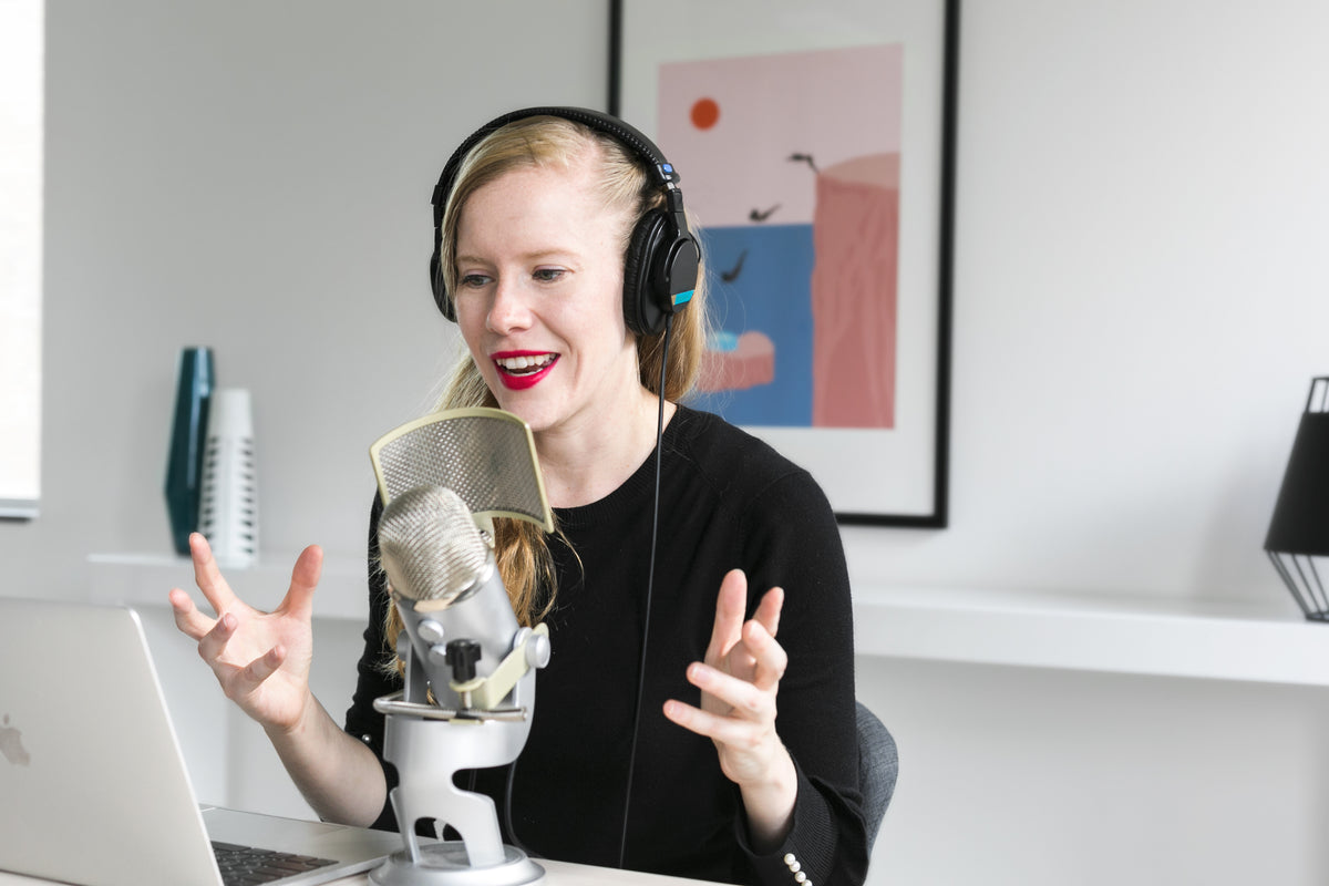 woman recording podcast at mic