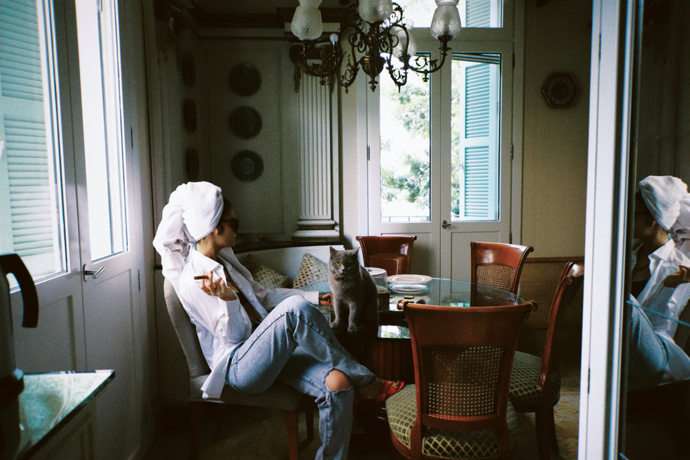 woman relaxing by dining table