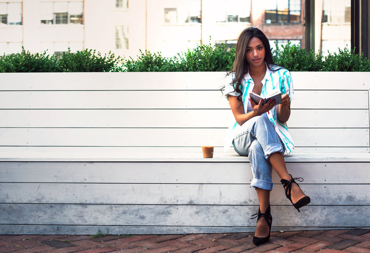 Woman Relaxing On Park Bench