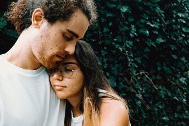 woman rests her head on a man shoulder