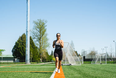 woman runs towards the camera outdoors