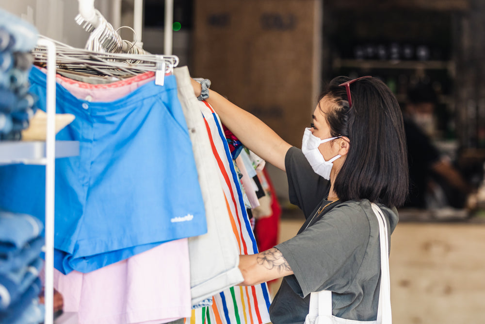 woman shops with her face mask in place