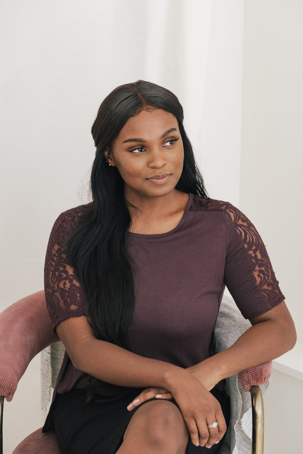 woman sits forward posing for camera