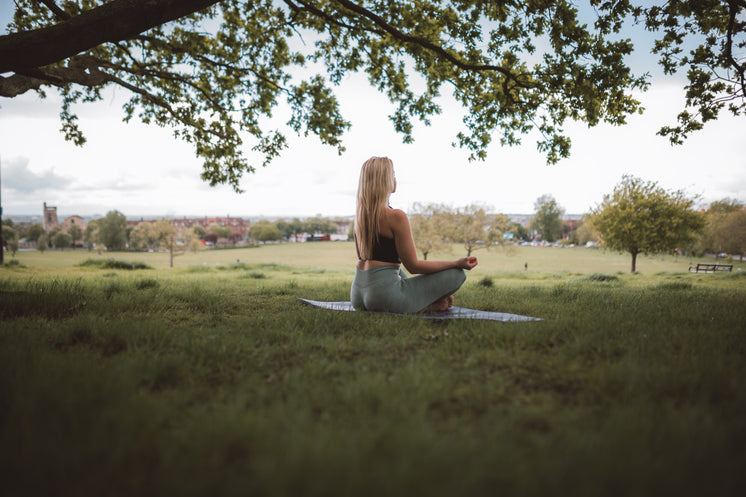 Woman Sits In Self Reflection Under A Tree