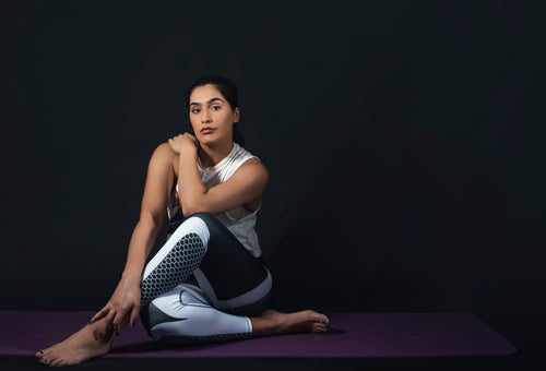 woman sits in yoga pose