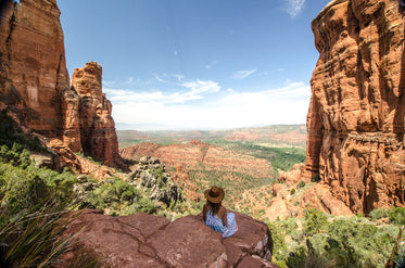 woman sits looking at desert