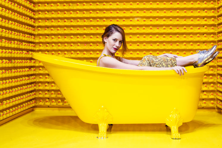 Woman Sits Up In A Yellow Bath