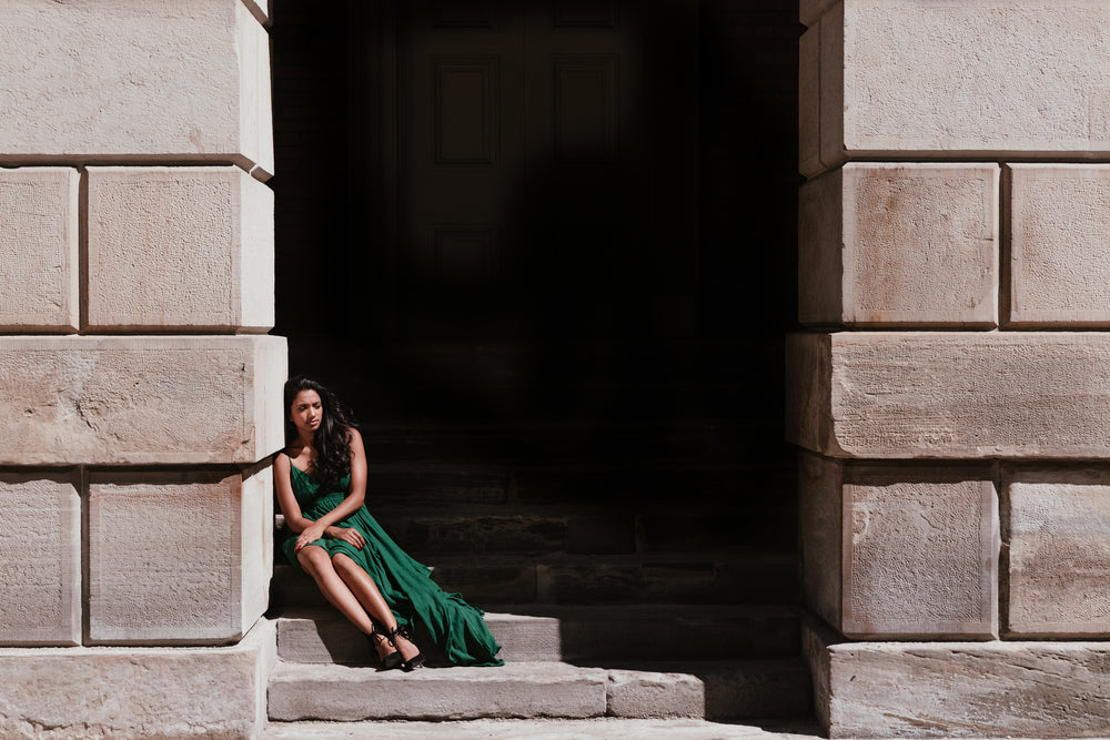 woman sitting in shadows on a staircase