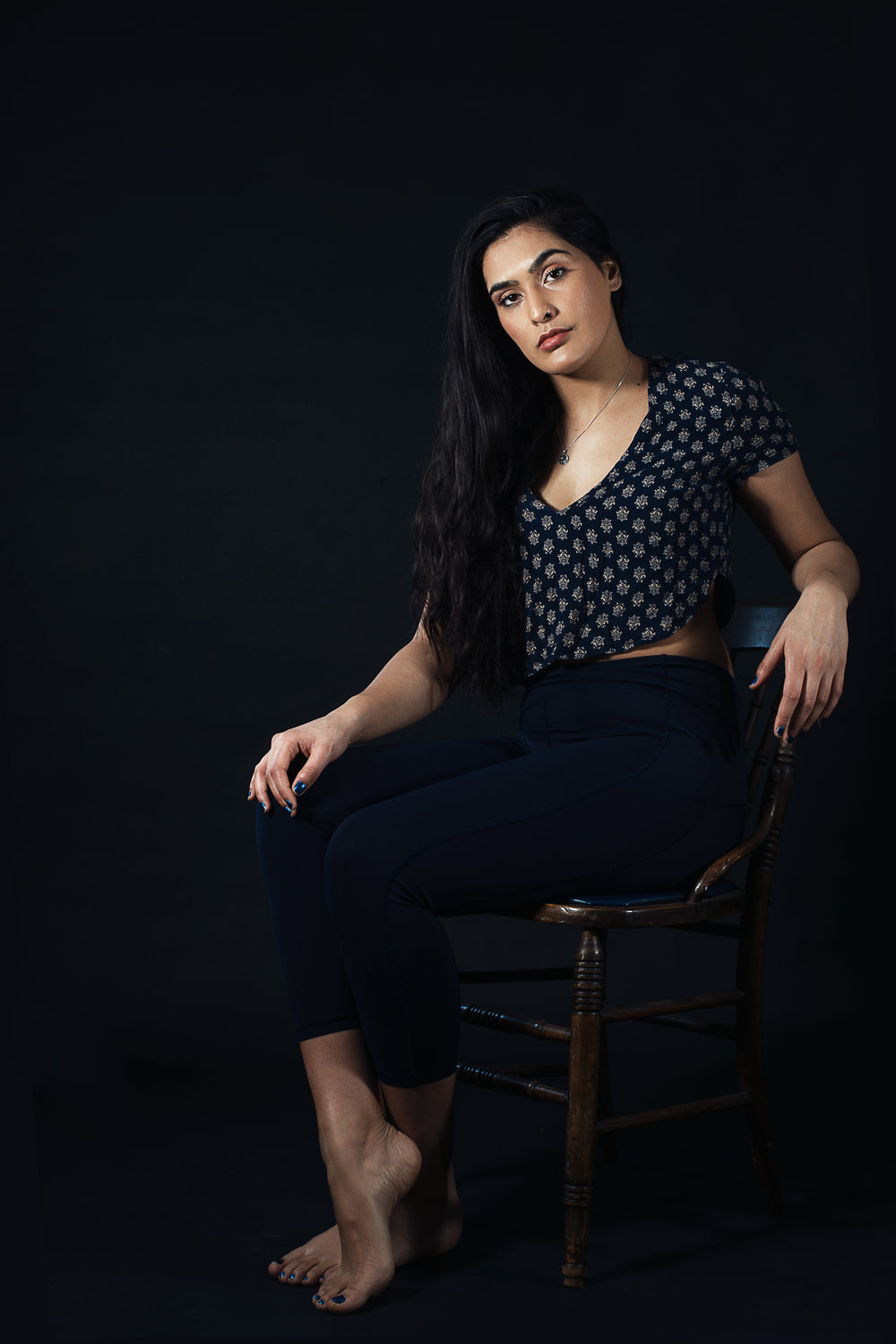 woman sitting on wooden chair