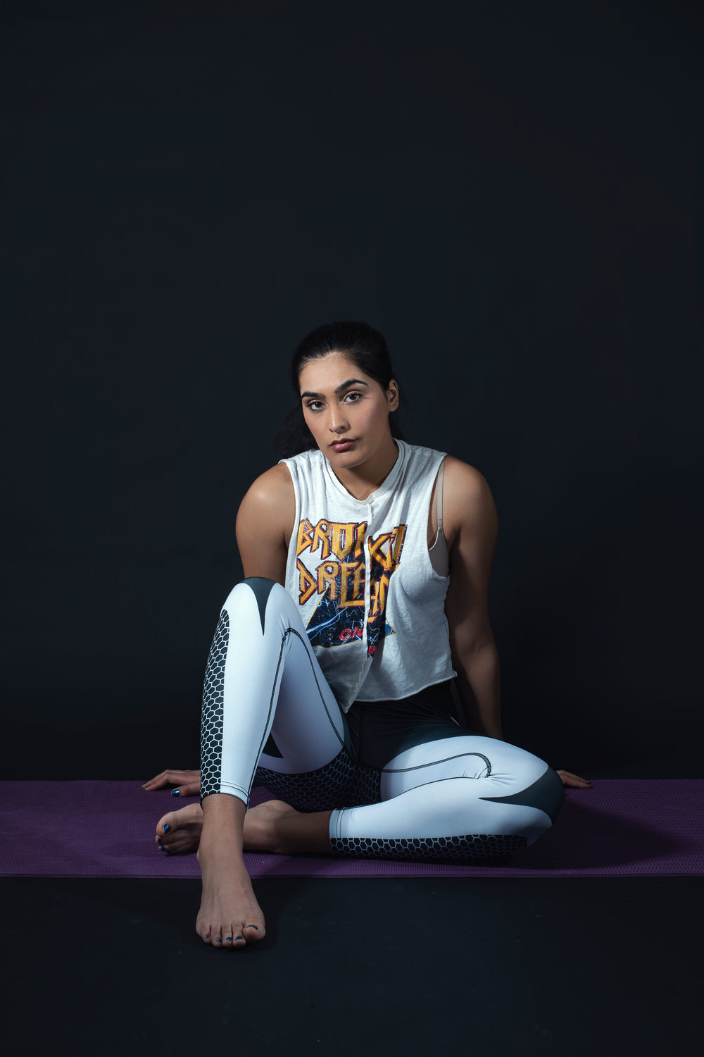 woman sitting on yoga mat