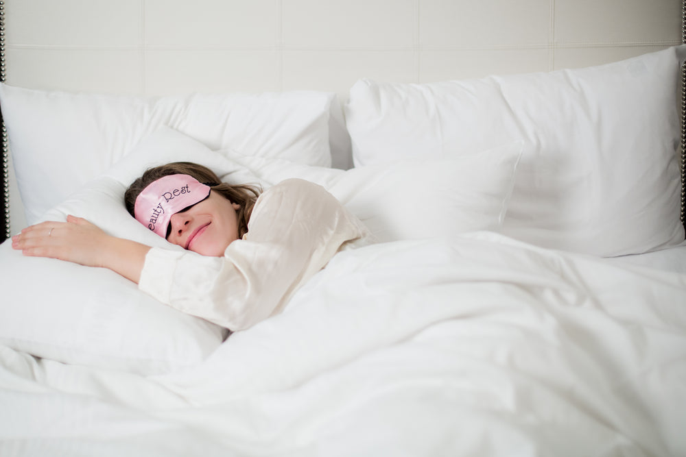 woman sleeping in white bed