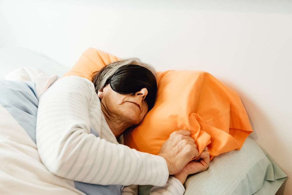 woman sleeping with a mask covering her eyes