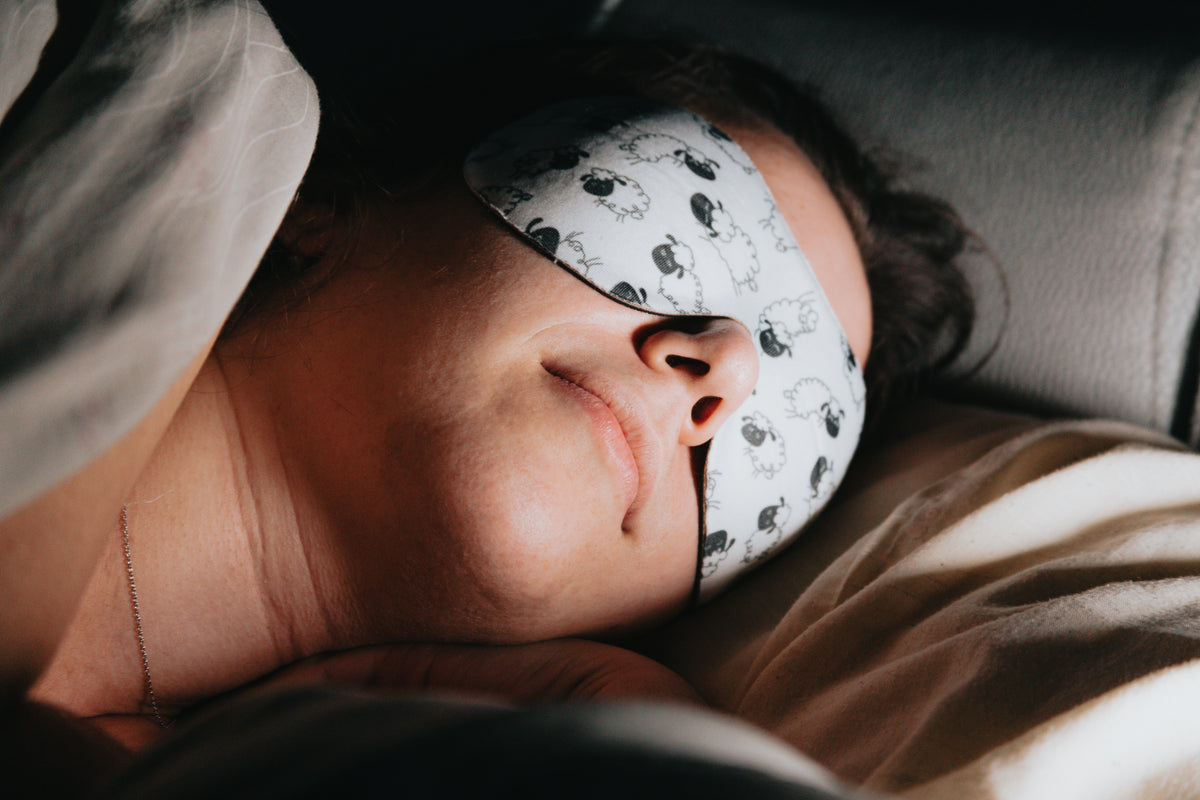 woman sleeps soundly with a mask over her eyes
