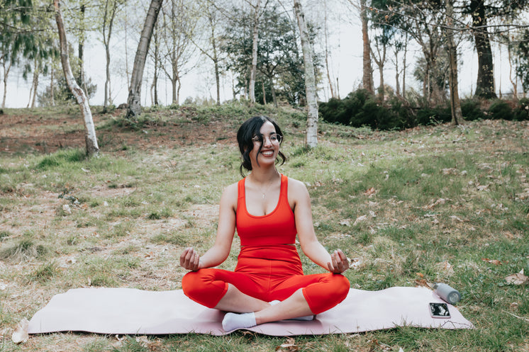 Woman Smiles While Sitting In A Yoga Pose