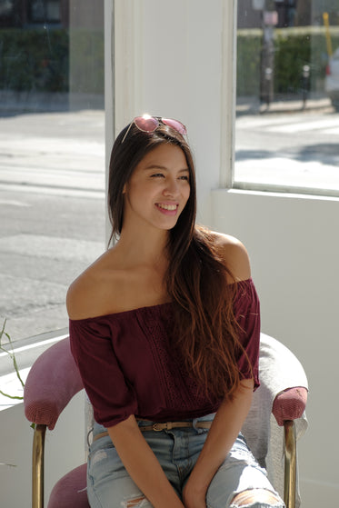 woman smiling while sat in sunny window