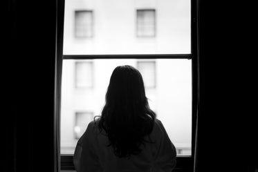 woman standing at window