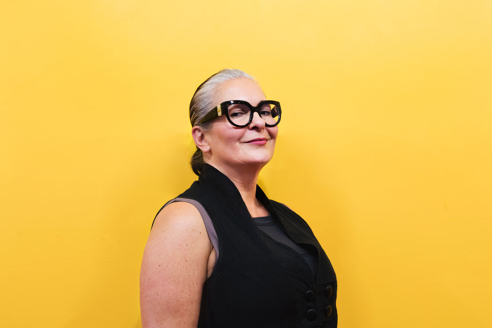 woman standing in front of yellow background