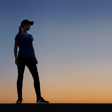 woman standing infront of perfect sunset