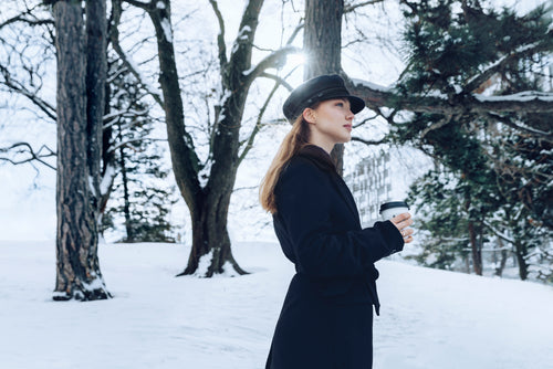 woman standing snowy wood