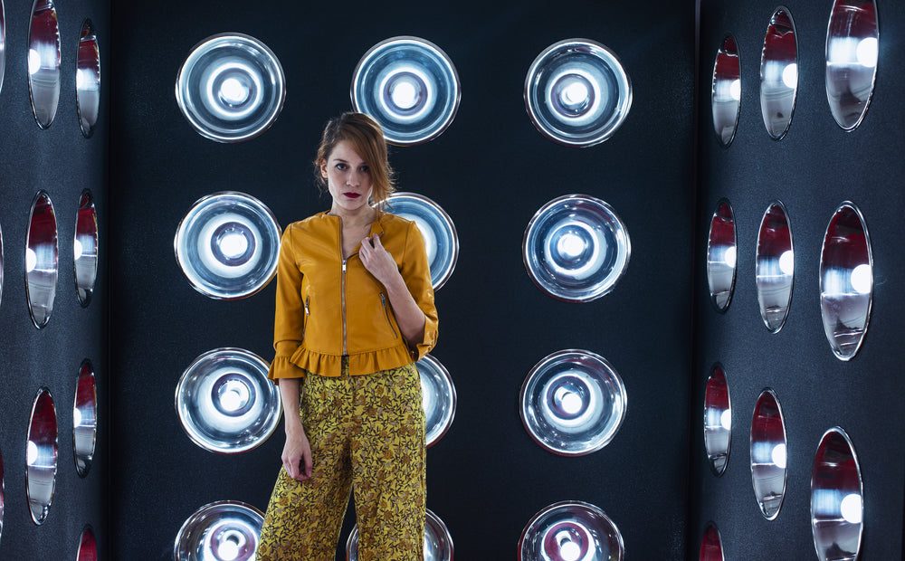 woman stands in small room with silver dome lights on walls