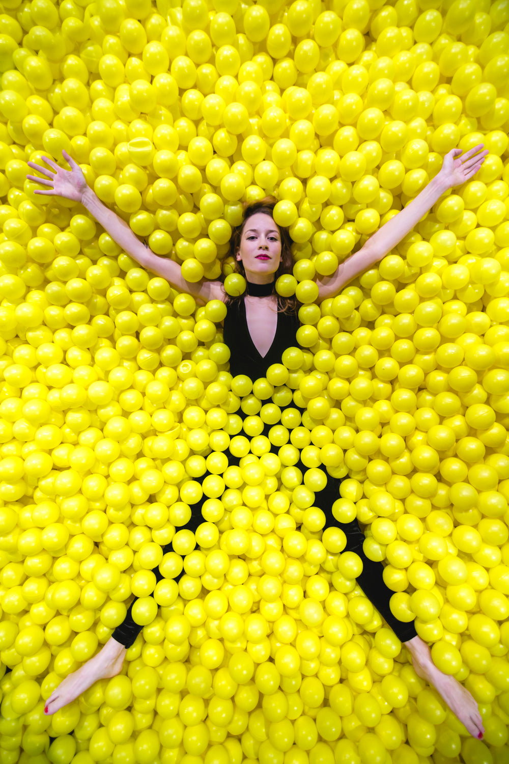 woman star fishes in ball pool
