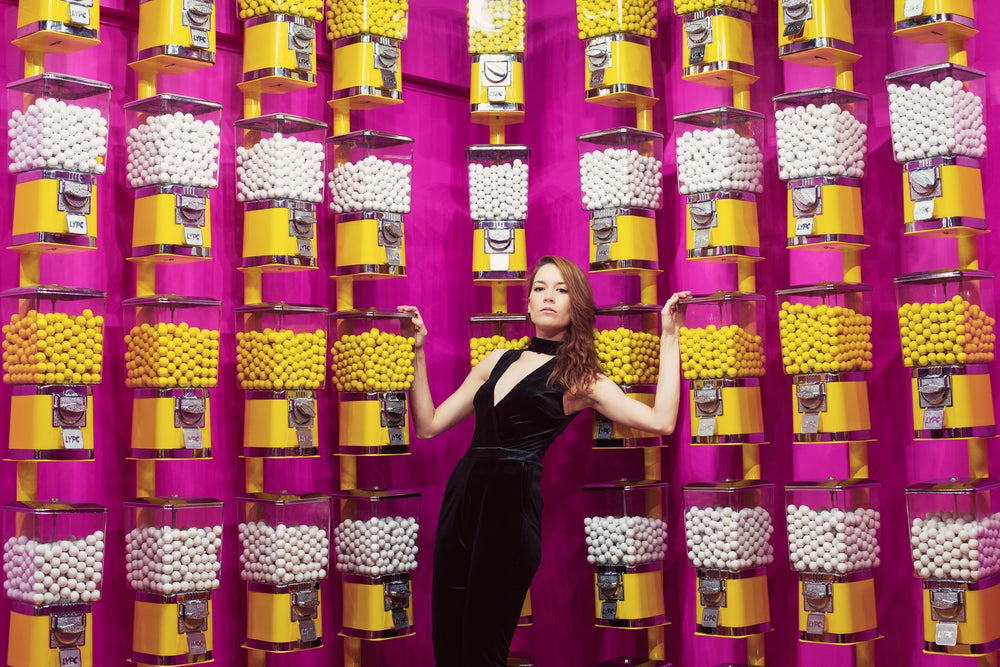 woman surrounded by gumball machine covered walls