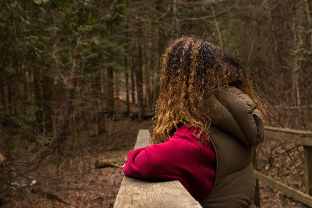 woman takes a moment while on a hike