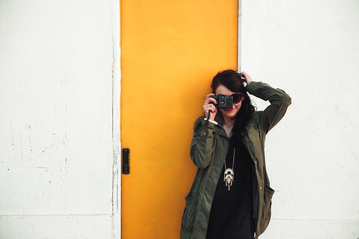 woman takes photo in front of door