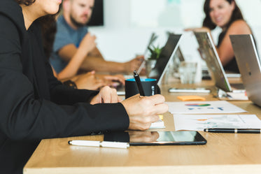 woman taking notes during team meeting