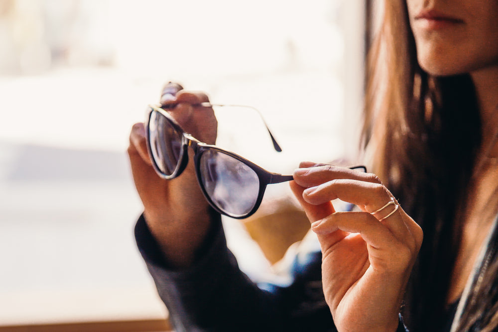 woman trying on sunglasses