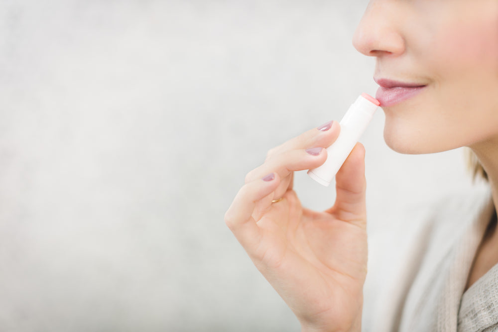 woman using lip balm