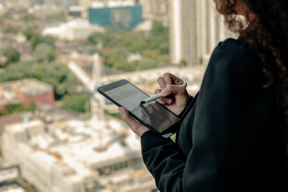 woman using ipad with stylus highrise office