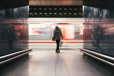 woman waits train speeds by