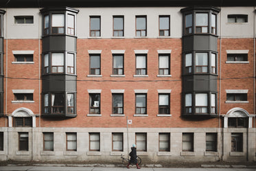 woman walking in front of apartment building